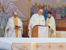 Father Gabriel Romanelli with Cardinal Pierbattista Pizzaballa, Latin Patriarch of Jerusalem, celebrating Christmas Mass at Holy Family Parish in Gaza, in December 2024.